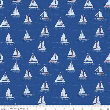 Image of the Yacht Club Sailboats Blue quilting cotton fabric by Amanda Niederhauser for Riley Blake Designs. Features boats on a blue background. Cute Little Fabric Shop