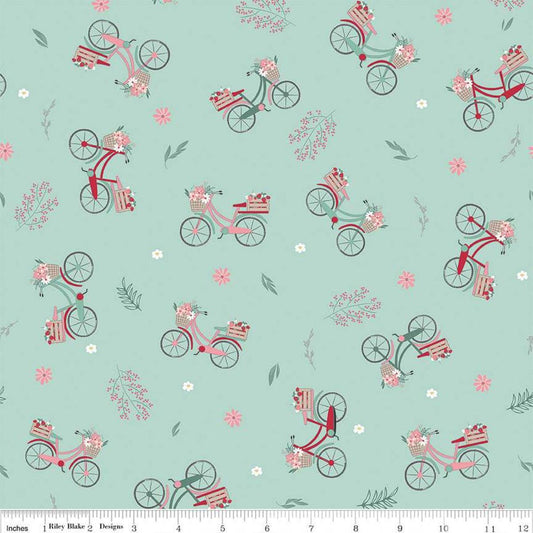 Image of the Berry Market Bicycles Mint quilting cotton fabric by Beverly McCullough for Riley Blake Designs. Features bikes on a blue background. Cute Little Fabric Shop