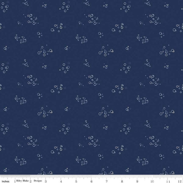 Image of the Yacht Club Bubbles Navy quilting cotton fabric by Amanda Niederhauser for Riley Blake Designs. Features circles on a blue background. Cute Little Fabric Shop
