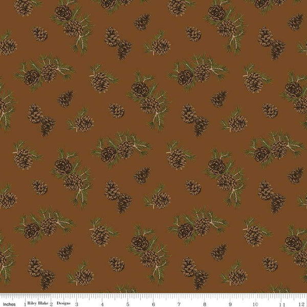 Image of the Pine Grove Pinecones Brown quilting cotton fabric by Riley Blake Designs. Features trees on a brown background. Cute Little Fabric Shop