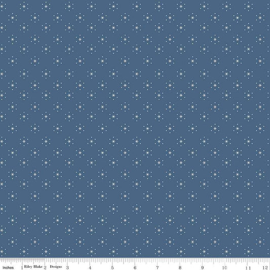 Image of the Americana Sparkle Denim quilting cotton fabric by Lori Holt for Riley Blake Designs. Features stars on a blue background. Cute Little Fabric Shop
