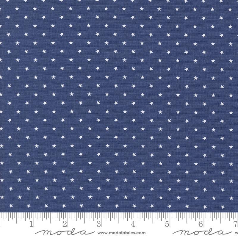 Image of the Star Spangled Twinkle Twilight quilting cotton fabric by Moda Fabrics. Features stars on a blue background. Cute Little Fabric Shop