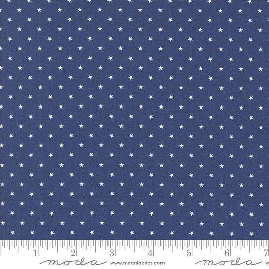 Image of the Star Spangled Twinkle Twilight quilting cotton fabric by Moda Fabrics. Features stars on a blue background. Cute Little Fabric Shop