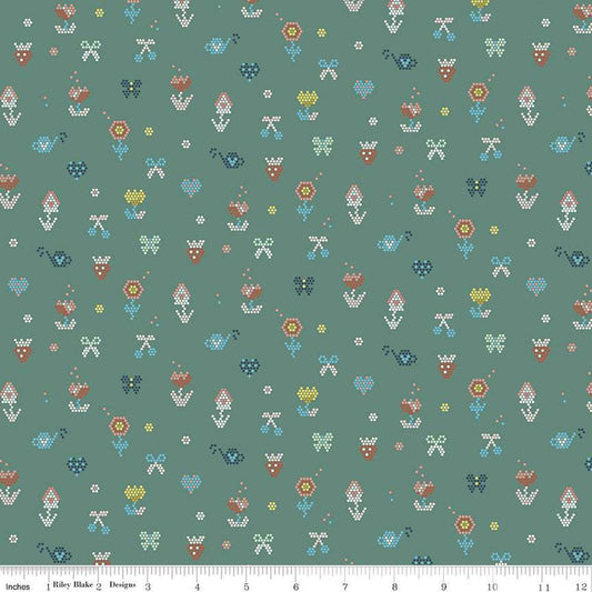 Image of the Sunsetridge Mosaic Lodge Pole quilting cotton fabric by Minki Kim for Riley Blake Designs. Features pixels on a green background. Cute Little Fabric Shop