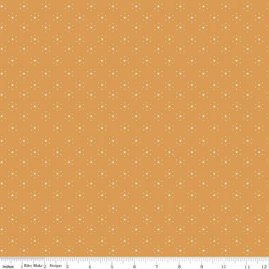 Image of the Americana Sparkle Cider quilting cotton fabric by Lori Holt for Riley Blake Designs. Features stars on a gold background. Cute Little Fabric Shop