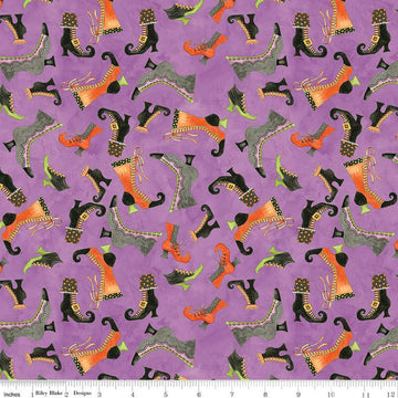 Image of the Ghoul Friends Boots Toss Purple quilting cotton fabric by Teresa Kogut for Riley Blake Designs. Features boots on a purple background. Cute Little Fabric Shop