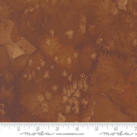 Image of the Wanderlust Flow Basics Soil quilting cotton fabric. Features paint on a brown background. Cute Little Fabric Shop