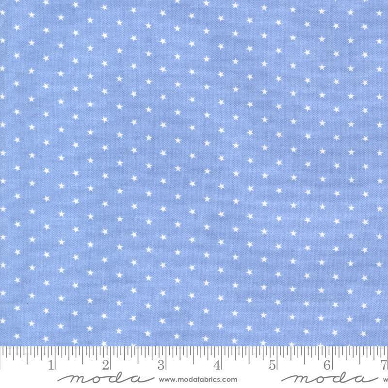 Image of the Star Spangled Twinkle Dawn quilting cotton fabric by Moda Fabrics. Features stars on a blue background. Cute Little Fabric Shop
