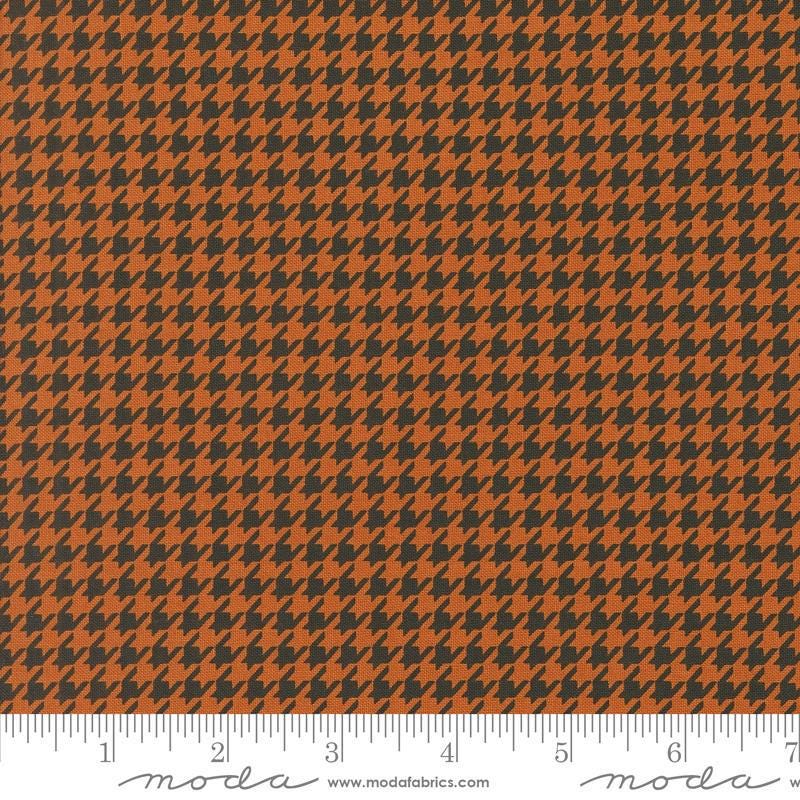Image of the Home Sweet Haunt Houndstooth Rust quilting cotton fabric by Moda Fabrics. Features houndstooth on an orange background. Cute Little Fabric Shop