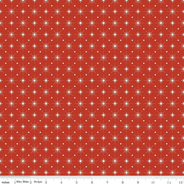 Image of Christmas Is in Town Stars Red by Riley Blake Designs. Features arranged sparkle stars on a red background. 
Cute Little Fabric Shop