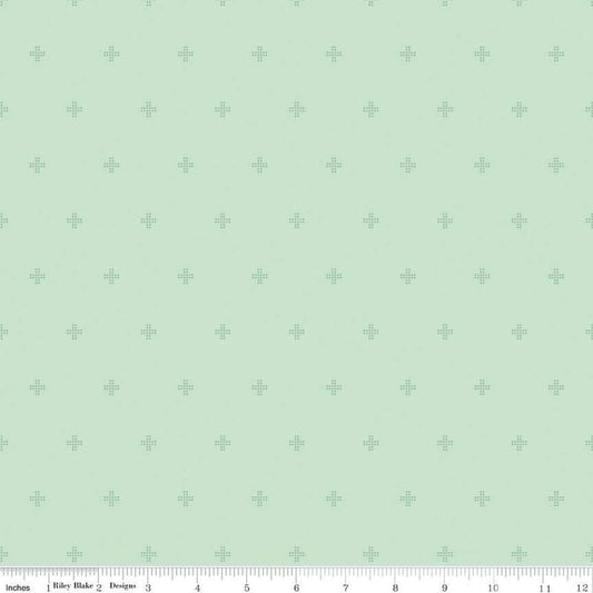 Image of the Sunsetridge Crosses Mint quilting cotton fabric by Minki Kim for Riley Blake Designs. Features pixels on a green background. Cute Little Fabric Shop