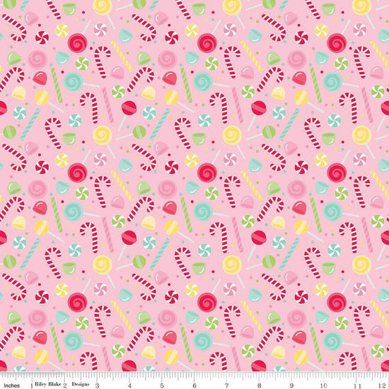Image of the Gingerbread Kisses Sweets Pink quilting cotton fabric. Features candy on a pink background. Cute Little Fabric Shop
