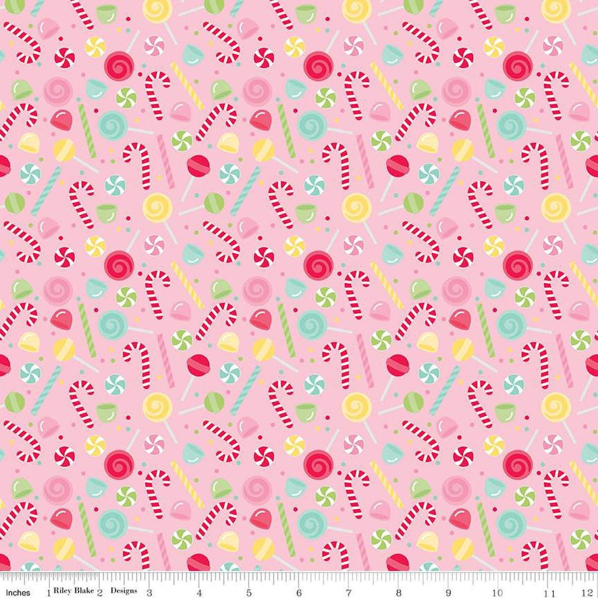 Image of the Gingerbread Kisses Sweets Pink quilting cotton fabric. Features candy on a pink background. Cute Little Fabric Shop