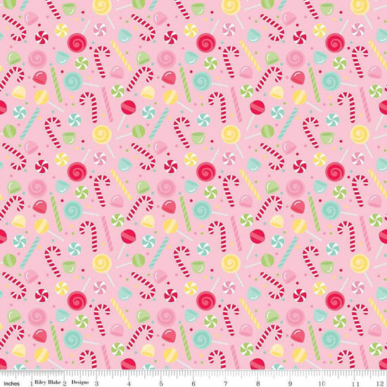 Image of the Gingerbread Kisses Sweets Pink quilting cotton fabric. Features candy on a pink background. Cute Little Fabric Shop