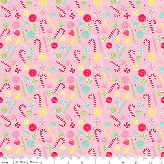 Image of the Gingerbread Kisses Sweets Pink quilting cotton fabric. Features candy on a pink background. Cute Little Fabric Shop