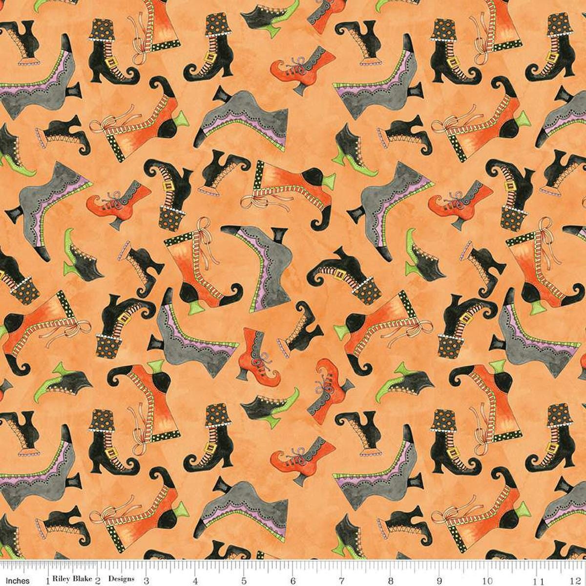Image of the Ghoul Friends Boots Toss Orange quilting cotton fabric by Teresa Kogut for Riley Blake Designs. Features boots on an orange background. Cute Little Fabric Shop