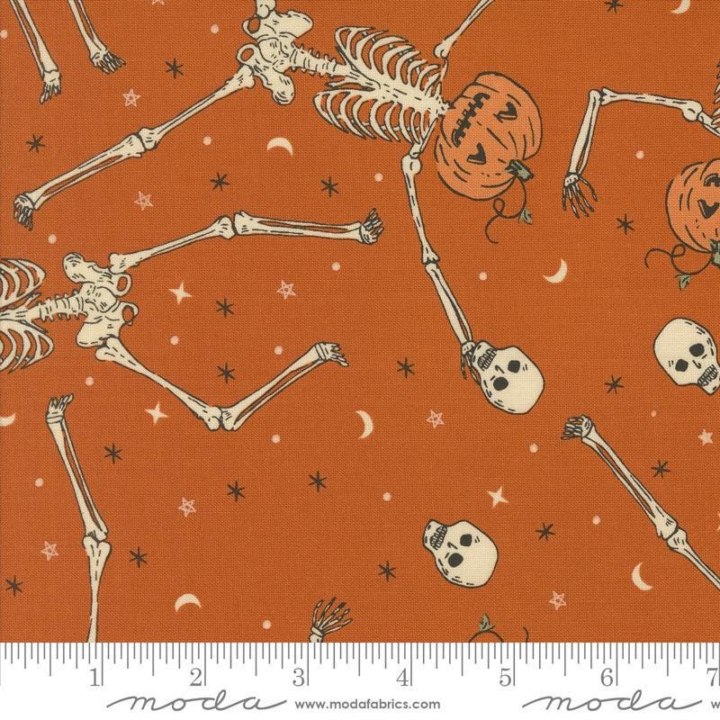 Image of the Home Sweet Haunt Skeletons Rust quilting cotton fabric by Moda Fabrics. Features halloween icons on an orange background. Cute Little Fabric Shop