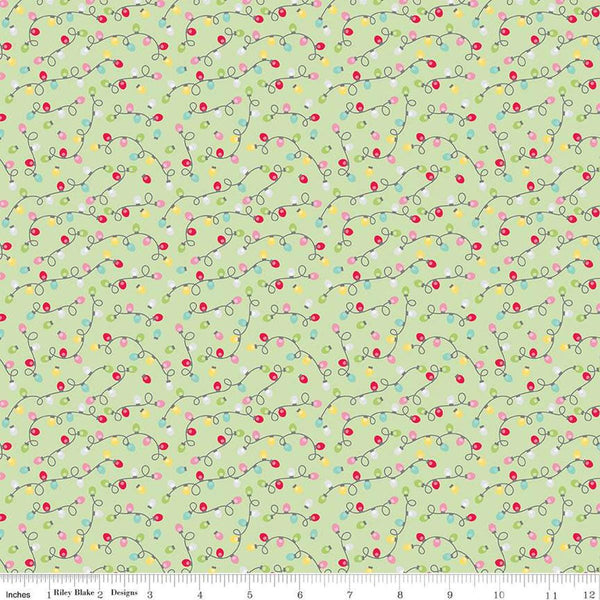 Image of the Gingerbread Kisses Lights Green quilting cotton fabric. Features lights on a green background. Cute Little Fabric Shop