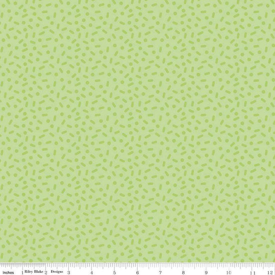 Image of the Gingerbread Kisses Sprinkles Green quilting cotton fabric. Features sprinkles on a green background. Cute Little Fabric Shop