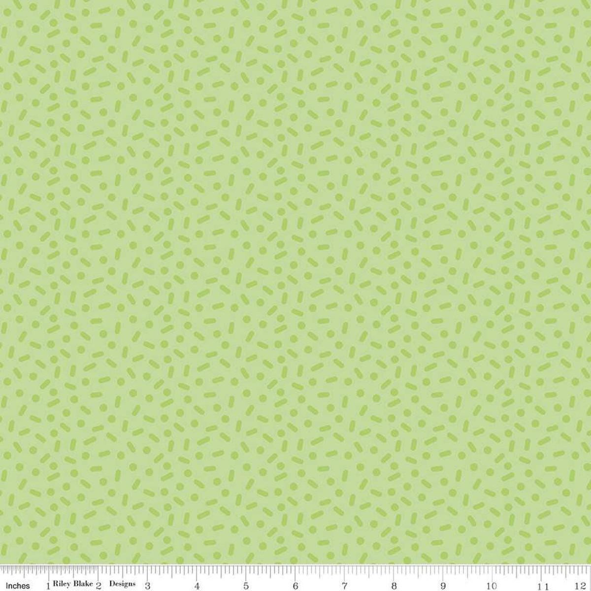 Image of the Gingerbread Kisses Sprinkles Green quilting cotton fabric. Features sprinkles on a green background. Cute Little Fabric Shop