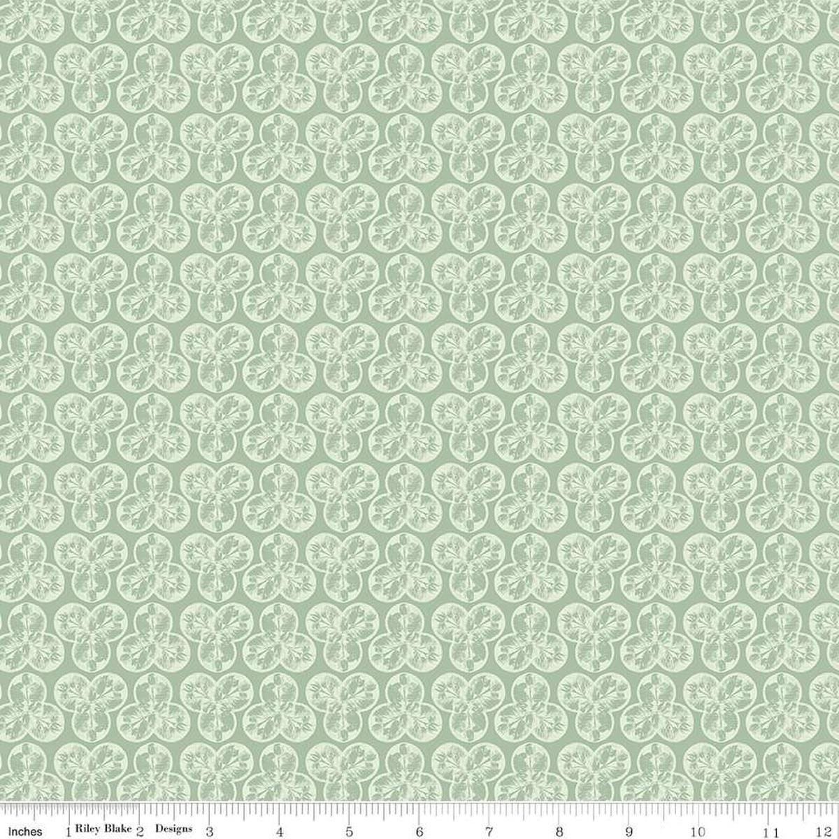 Image of the Nature's Portrait Trifolium Sage quilting cotton fabric by Riley Blake Designs. Features leaves on a green background. Cute Little Fabric Shop