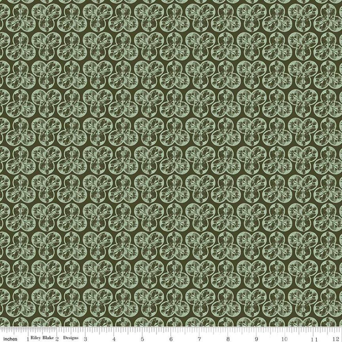 Image of the Nature's Portrait Trifolium Hunter quilting cotton fabric by Riley Blake Designs. Features leaves on a green background. Cute Little Fabric Shop