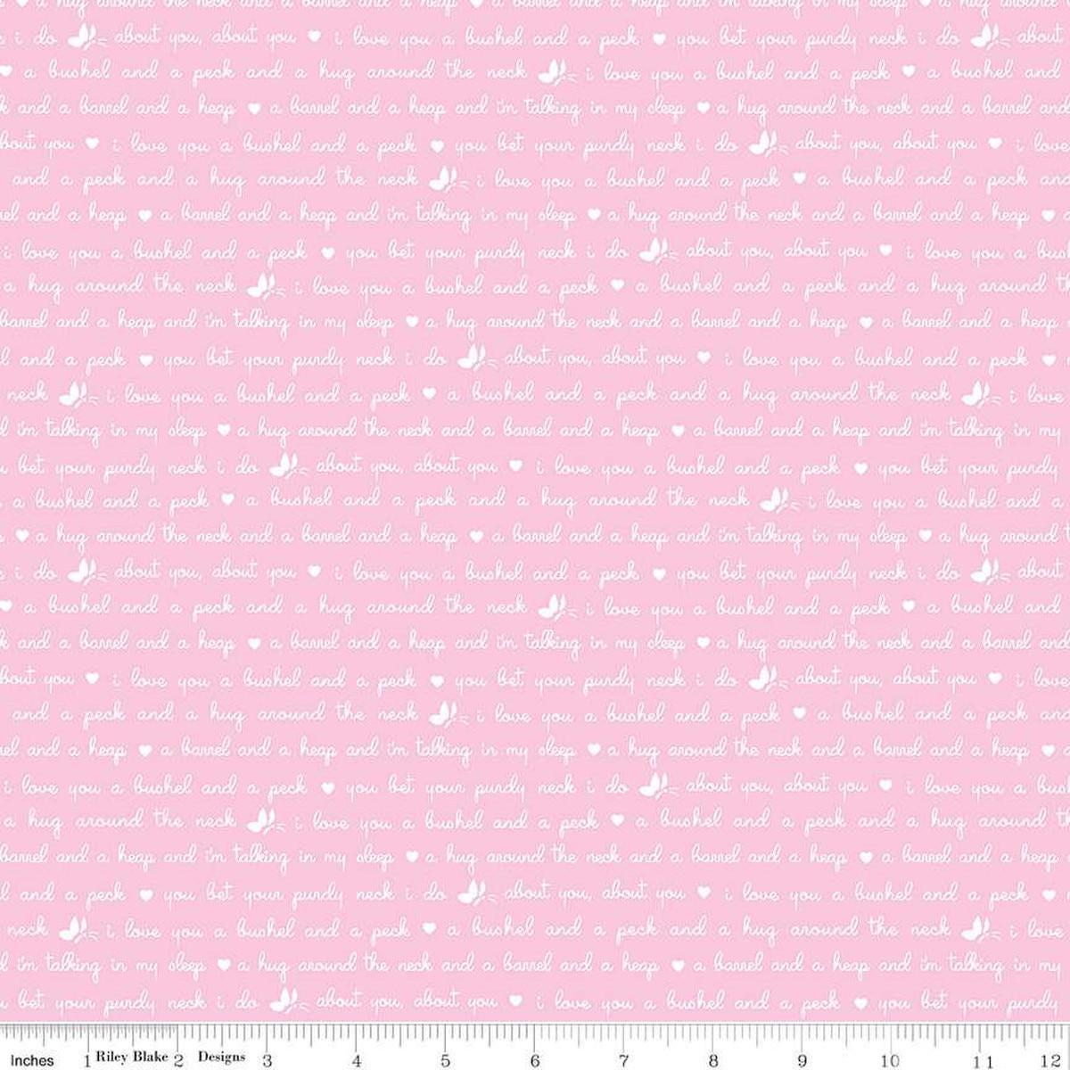 Image of the Love Notes Text Pink quilting cotton fabric by Riley Blake Designs. Features text on a pink background. Cute Little Fabric Shop