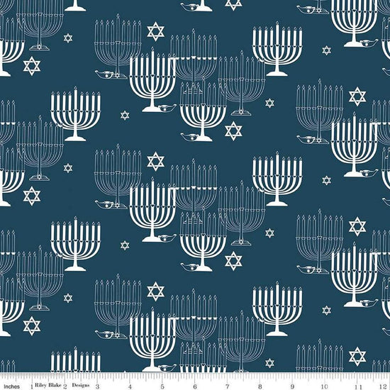 Image of the 8 Nights, 8 Lights Main Navy quilting cotton fabric by Riley Blake Designs. Features stars on a blue background. Cute Little Fabric Shop