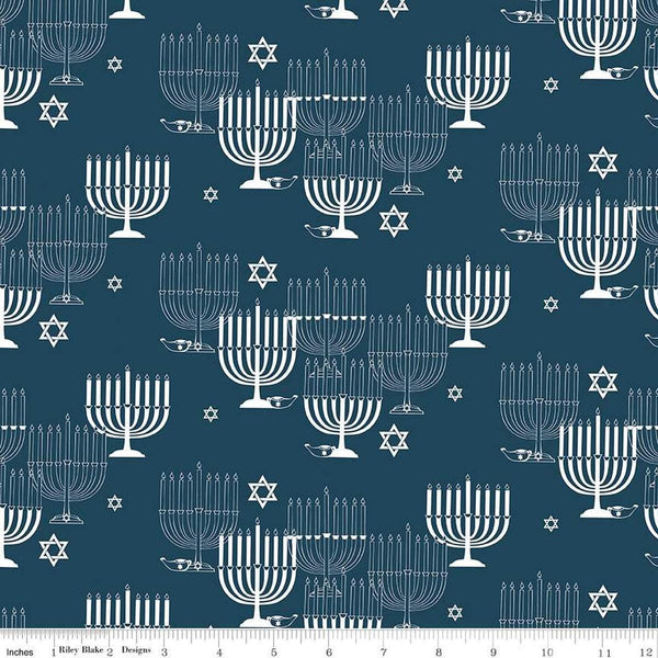 Image of the 8 Nights, 8 Lights Main Navy quilting cotton fabric by Riley Blake Designs. Features stars on a blue background. Cute Little Fabric Shop