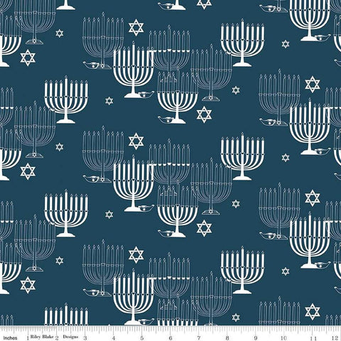 Image of the 8 Nights, 8 Lights Main Navy quilting cotton fabric by Riley Blake Designs. Features stars on a blue background. Cute Little Fabric Shop