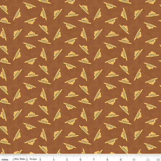 Image of the Friends of Smokey Bear Hat Toss Sienna quilting cotton fabric. Features hats on a brown background. Cute Little Fabric Shop