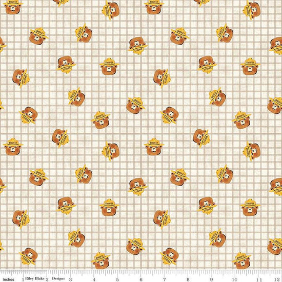 Image of the Friends of Smokey Bear Head Toss Cream quilting cotton fabric. Features smokey heads on a cream background. Cute Little Fabric Shop