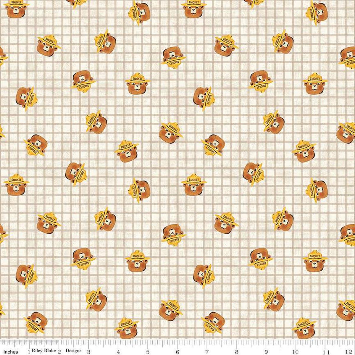 Image of the Friends of Smokey Bear Head Toss Cream quilting cotton fabric. Features smokey heads on a cream background. Cute Little Fabric Shop