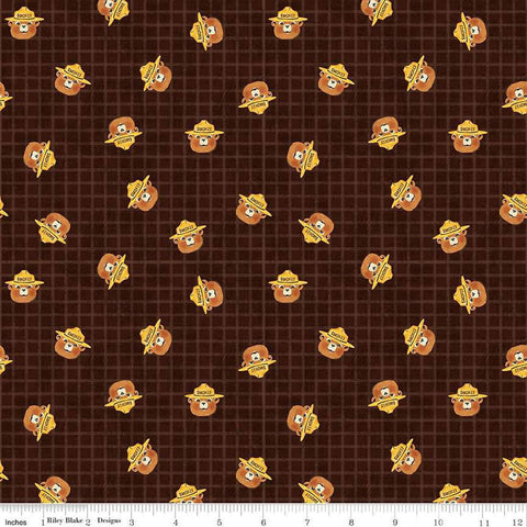 Image of the Friends of Smokey Bear Head Toss Bark quilting cotton fabric. Features smokey heads on a green background. Cute Little Fabric Shop