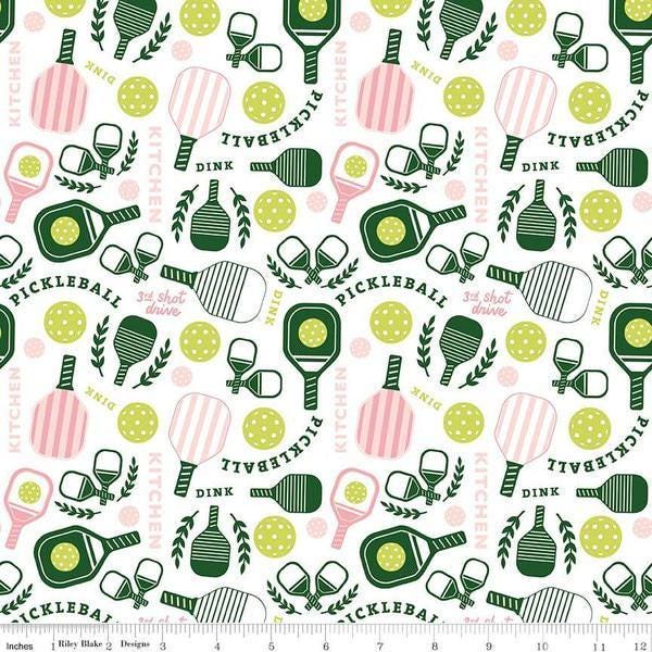 Image of the Pickleball Main White quilting cotton fabric by Riley Blake Designs. Features pickleball items on a white background. Cute Little Fabric Shop