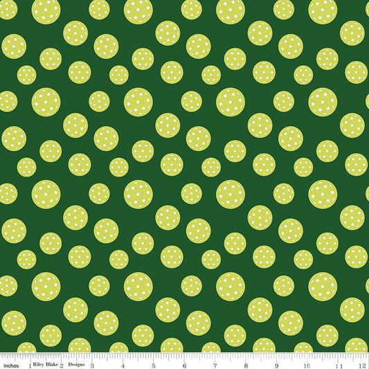 Image of the Pickleball Pickleballs Green quilting cotton fabric by Riley Blake Designs. Features pickleballs on a green background. Cute Little Fabric Shop