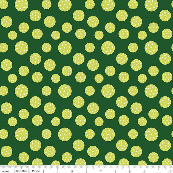 Image of the Pickleball Pickleballs Green quilting cotton fabric by Riley Blake Designs. Features pickleballs on a green background. Cute Little Fabric Shop