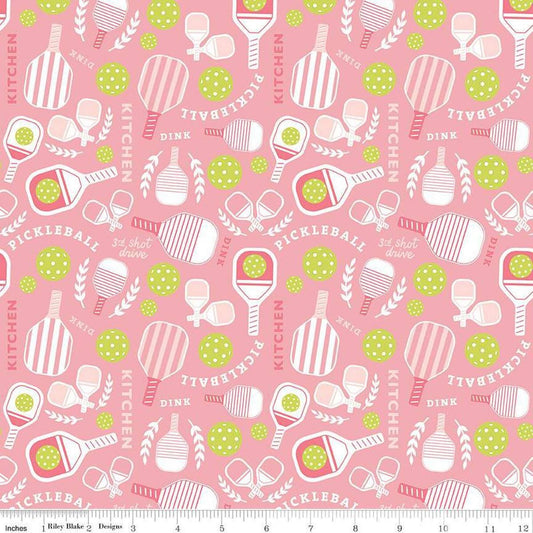 Image of the Pickleball Main Pink quilting cotton fabric by Riley Blake Designs. Features pickleball items on a pink background. Cute Little Fabric Shop
