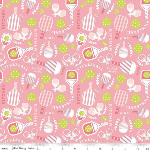 Image of the Pickleball Main Pink quilting cotton fabric by Riley Blake Designs. Features pickleball items on a pink background. Cute Little Fabric Shop