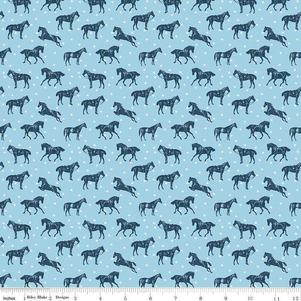 Image of the Bluegrass Charm Horses Sky quilting cotton fabric by Riley Blake Designs. Features horses on a blue background. Cute Little Fabric Shop