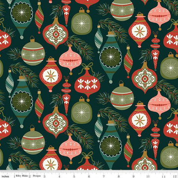 Image of Christmas Is in Town Ornaments Forest by Riley Blake Designs. Features Christmas ornaments on a dark green background with sprigs of pine needles. 
Cute Little Fabric Shop