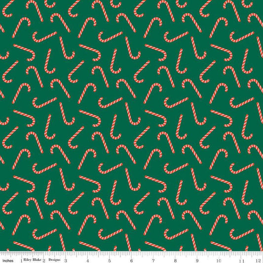 Image of the Flannel Candy Canes Green quilting cotton fabric by Riley Blake Designs. Features candy canes on a green background. Cute Little Fabric Shop