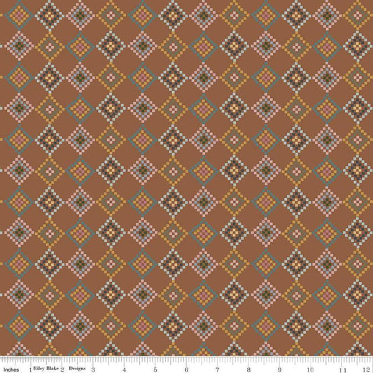 Image of the Honey Locust Patchwork Saddle quilting cotton fabric by Riley Blake Designs. Features flowers on a brown background