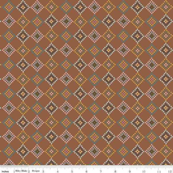 Image of the Honey Locust Patchwork Saddle quilting cotton fabric by Riley Blake Designs. Features flowers on a brown background