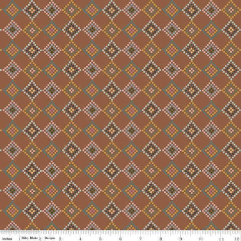 Image of the Honey Locust Patchwork Saddle quilting cotton fabric by Riley Blake Designs. Features flowers on a brown background