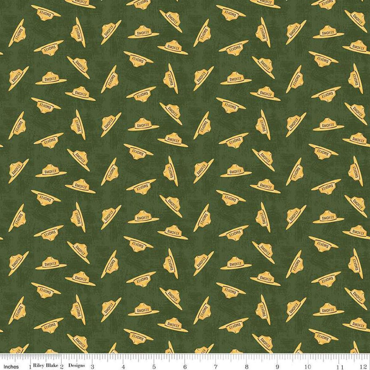 Image of the Friends of Smokey Bear Hat Toss Forest quilting cotton fabric. Features hats on a green background. Cute Little Fabric Shop