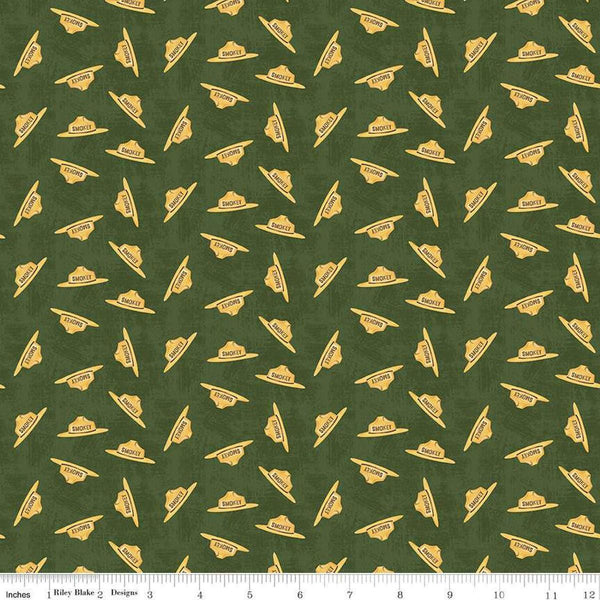 Image of the Friends of Smokey Bear Hat Toss Forest quilting cotton fabric. Features hats on a green background. Cute Little Fabric Shop
