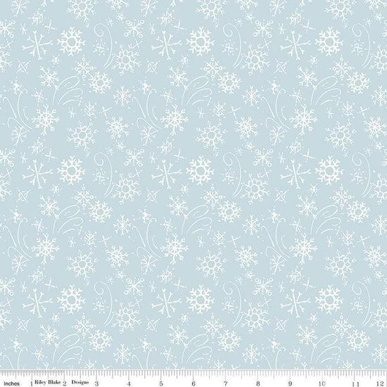 Image of the Santa's Tree Farm Snowflake Sky quilting cotton fabric by Riley Blake Designs. Features snowflakes on a blue background. Cute Little Fabric Shop