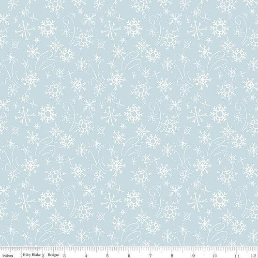 Image of the Santa's Tree Farm Snowflake Sky quilting cotton fabric by Riley Blake Designs. Features snowflakes on a blue background. Cute Little Fabric Shop