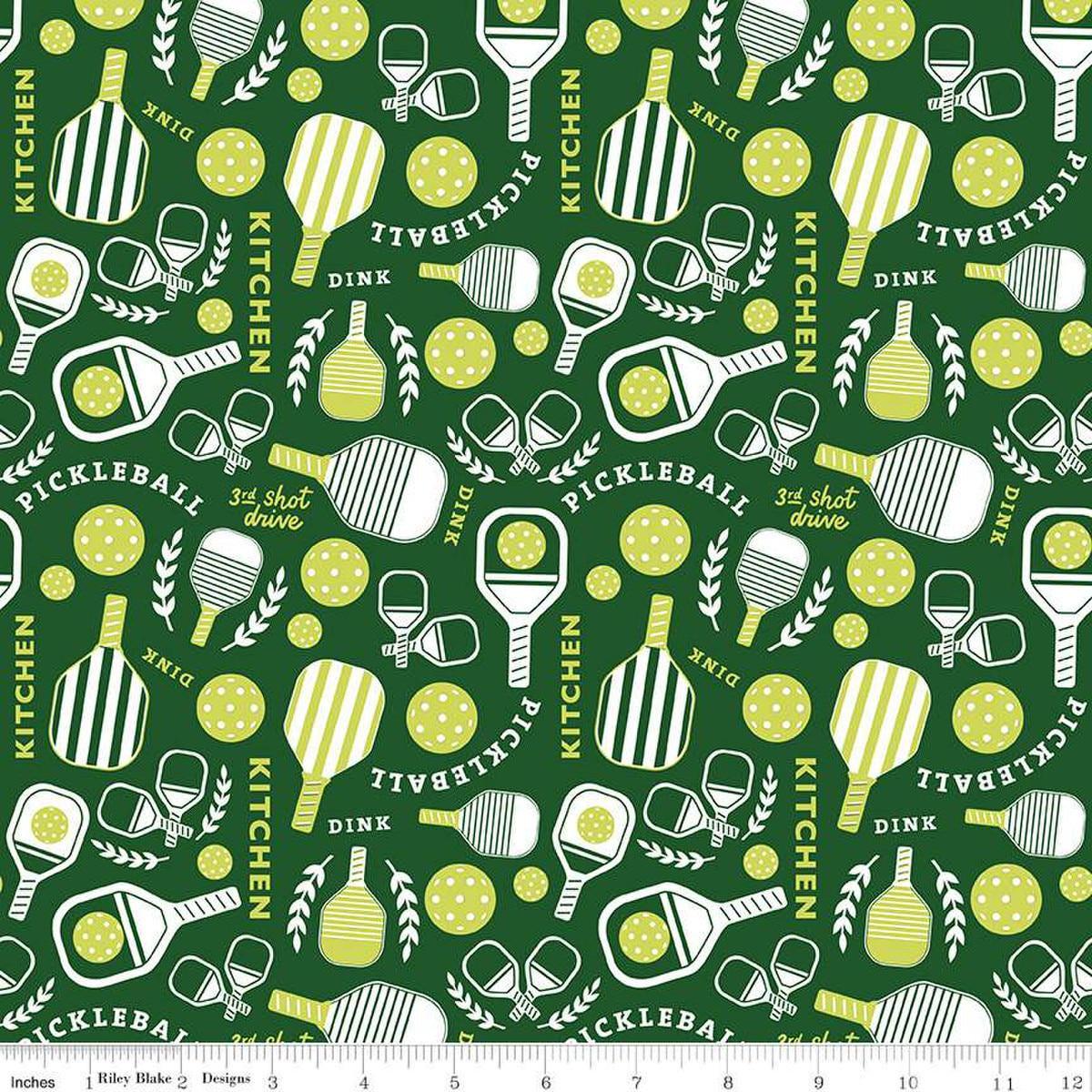 Image of the Pickleball Main Green quilting cotton fabric by Riley Blake Designs. Features pickleball items on a green background. Cute Little Fabric Shop